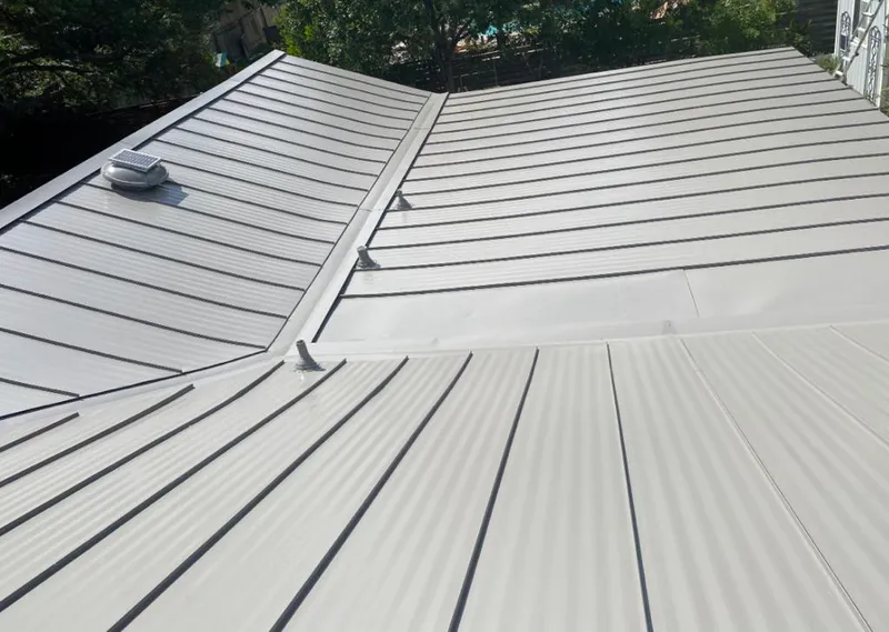 Solar attic fan installed on a metal roof for Roof Ventilation in Springfield